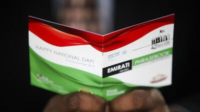 Phrase books teaching Emirati dialect Arabic are being given out to bring expatriates and Emiratis together as they celebrate National Day. Lee Hoagland / The National