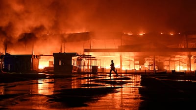 A firefighter works at the site of a shopping centre which was hit by a late evening Russian drone strike in Zaporizhzhia, Ukraine. Reuters