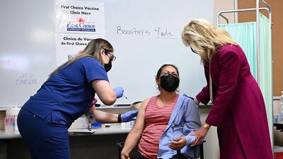 US first lady Jill Biden speaks to a woman receiving a Covid-19 vaccine during her visit to a vaccination centre in Albuquerque, New Mexico, on April 21, 2021. Reuters