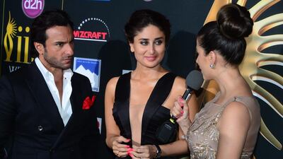 Bollywood stars Kareena Kapoor and her husband Saif Ali Khan meet the press on the green carpet. Frederic J. Brown / AFP