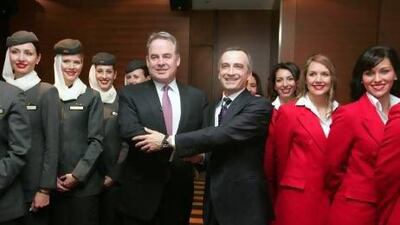 James Hogan, the chief executive of Etihad Airways, left, with John Borghetti, his counterpart at Virgin Blue Holdings, announce the partnership between the two companies in 2010. Sergio Dionisio / Bloomberg News