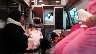 Mohammad Yousaf, in the arms of his mother, is brought to the Abu Dhabi International Airport by ambulance.