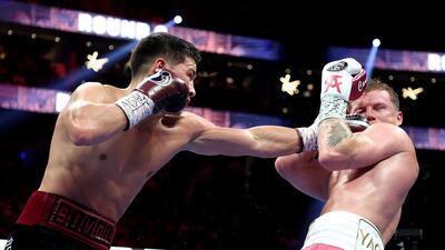 Dmitry Bivol throws a left at Canelo Alvarez during their WBA light heavyweight title fight at T-Mobile Arena.