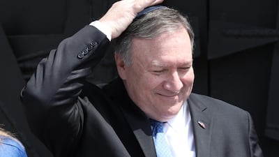 US Secretary of State Mike Pompeo touches his skullcap after signing the guestbook at the Yad Vashem Holocaust memorial museum in Jerusalem. EPA