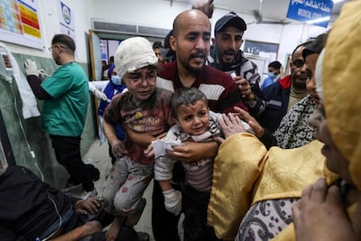 Children injured in an Israeli bombardment are brought into Al Najjar hospital in Rafah, southern Gaza. AFP
