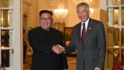 North Korea's leader Kim Jong-un is welcomed by Singapore's Prime Minister Lee Hsien Loong following Kim's arrival in Singapore on June 10, 2018. Roslan Rahman / AFP