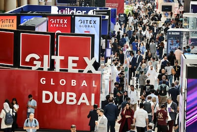 Visitors are seen on the first day of the Gitex Global technology conference in Dubai on Monday. Pawan Singh / The National