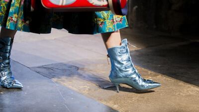Metallic multi-buckle ankle boots walk the runway for Gucci. Courtesy Gucci