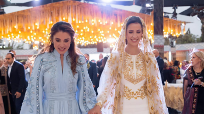 Queen Rania and Rajwa Al Saif walk hand-in-hand