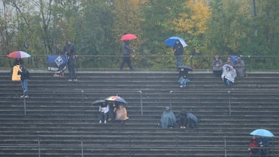 Fans endure the rain at the Nurburgring racetrack. AP