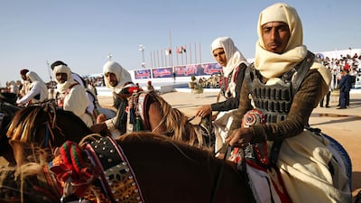 Libyan dressed in traditional costumes attend a military parade in the eastern city of Benghazi on May 7, 2018, during which Libyan strongman Khalifa Haftar announced a military offensive to take from "terrorists" the city of Derna, the only part of eastern Libya outside his forces' control. Abdullah Doma / AFP