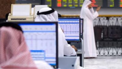 Traders work at the Bahrain Stock Exchange in Manama, Bahrain, Sunday, Aug. 26, 2007. Photographer: Charles Crowell/Bloomberg News