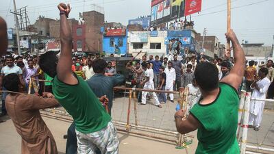 Supporters of Pakistan’s cricketer-turned-politician Imran Khan, in green shirts, clash with supporters of the ruling party in Gujranwala on August 15, 2014. KM Chaudary / AP Photo