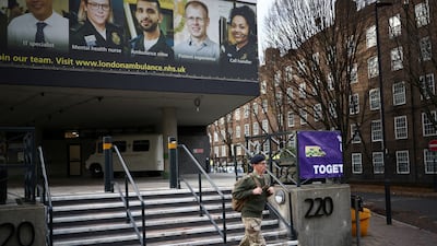 A military member walks outside NHS London Ambulance Service, on the day of a planned ambulance strike, amid a dispute with the government over pay. Reuters