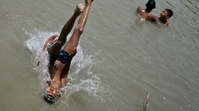 A boy dives into a lake to cool off in New Delhi. Increasing areas of concrete and shrinking green areas have increased urban heat, says Mahesh Palawat, of private forecaster Skymet Weather. AFP