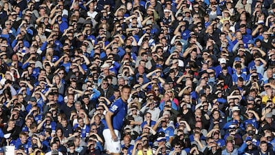 Everton fans shield their eyes from the sun during their club's Premier League match against Aston Villa at Goodison Park on Saturday. Andrew Yates / Reuters