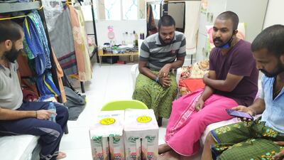 Workers pictured with a parcel of food they received from St Mary's Catholic Church. Courtesy: St Mary's Catholic Church