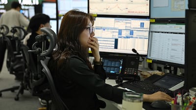 Currency dealers monitor exchange rates at the Hana Bank headquarters in Seoul on March 4. AFP