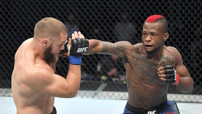 Marc Diakiese, right, of the Democratic Republic of the Congo punches Rafael Fiziev of Kazakhstan in their lightweight bout during the UFC Fight Night event inside Flash Forum on UFC Fight Island in Yas Island, Abu Dhabi. Photo by Jeff Bottari / Zuffa LLC via Getty Images