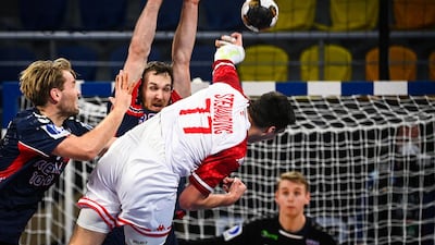 Austria's right back Nikola Stevanovic jumps and shoots to score during the 2021 World Men's Handball Championship match between Group E teams Norway and Austria at the 6th of October Sports Hall in 6th of October city, a suburb of the Egyptian capital Cairo. AFP