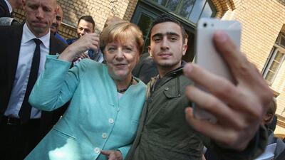 German chancellor Angela Merkel poses for a selfie with Syrian refugee Anas Modamani on September 10, 2015 in Berlin, Germany. Sean Gallup/Getty Images