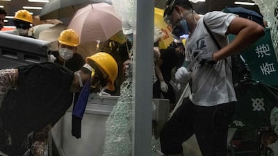 Protesters smash glass doors and windows of the government headquarters. AFP