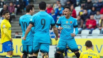 Barcelona's Neymar, second from right, celebrates a goal with teammates Lionel Messi, second from left, and Luis Suarez during their Primera Liga match against Las Palmas at the Gran Canaria stadium in Las Palmas de Gran Canaria on February 20, 2016. / AFP / JAIME REINA