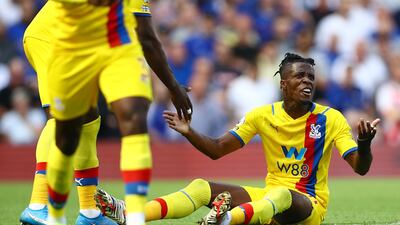 Crystal Palace's Wilfried Zaha complains to the referee.