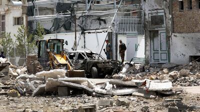Security personnel (C) are seen among damaged buildings a day after a suicide attack followed by a gunfight against the office of Afghan former chief of intelligence and current candidate for first vice president of Ashraf Ghani, in Kabul, Afghanistan. According to reports, at least 20 people were killed and 50 others wounded in the incident which targeted the office of Amrullah Saleh. EPA