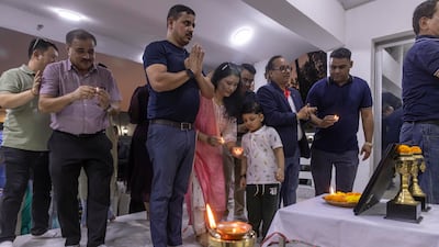 People bow their heads in prayer for the victims
