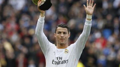 Real Madrid's Cristiano Ronaldo holds his Ballon d'Or trophy to the crowd, before their Primera Liga match against Granada at the Santiago Bernabeu stadium in Madrid. Juan Medina / Reuters