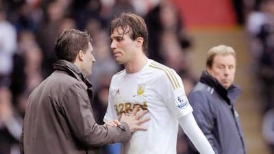 Swansea City's Michu, centre, and manager Michael Laudrup have both stated their intention to stay with the Welsh club.