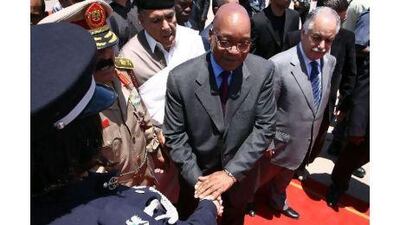 South African President Jacob Zuma (centre) shakes hands with an honour guard member as he is greeted by the Libyan prime minister, Baghdadi al Mahmudi, (right) upon his arrival in Tripoli yesterday for talks on ending a conflict with rebels fighting to oust Muammar Qaddafi. Mahmud Turkia / AFP Photo