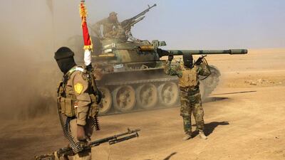 Fighters of the Popular Mobilisation Forces at the front line against Islamic State militants outside Mosul. Iraq's parliament has voted to accord full legal status to government-sanctioned Shiite militias as a back-up and reserve force for the military and police and to empower them to deter security and terror threats facing the country. Anmar Khalil / AP Photo