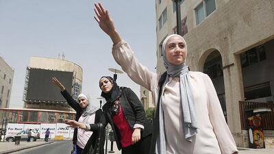 SheCab leaders Rahmeh Abu Shweimeh, front, Maha Al Amad, centre, and Sura Al Mahasis are three of the students who hope to make getting a taxi a more female-friendly experience in Jordan. Salah Malkawi for The National