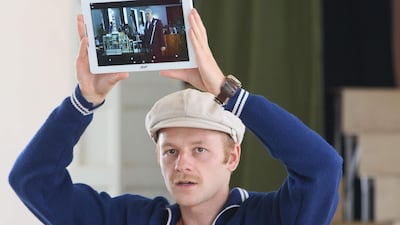 The tour guide holds up a tablet showing a still of the HBO series "Chernobyl."