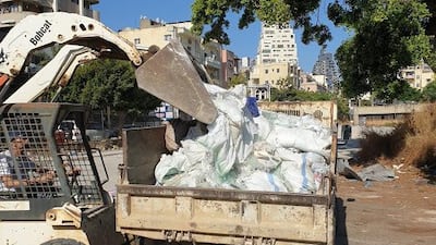 Pick up trucks going door to door to collect the shattered glass. Courtesy Ziad Abi Chaker