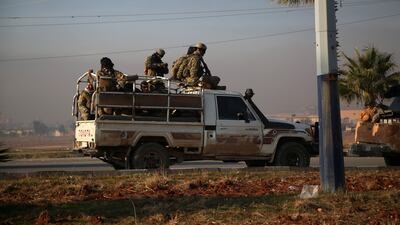 Armed men in Aleppo after rebel forces took control of the city. EPA