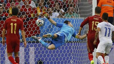 Spain goalkeeper Iker Casillas dives trying to save a ball from Chile's Charles Aranguiz (not pictured) during their match on Wednesday at the 2014 World Cup in Rio de Janeiro, Brazil. Pilar Olivares / Reuters