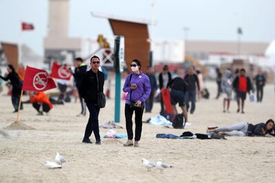 Wrapped up beachgoers take a walk. Chris Whiteoak / The National