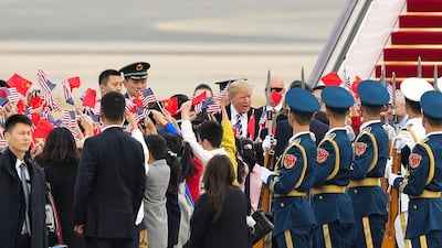 US President Donald Trump is greeted, as he and first lady Melania Trump arrive in Beijing, China. Lintao Zhang / AFP Photo
