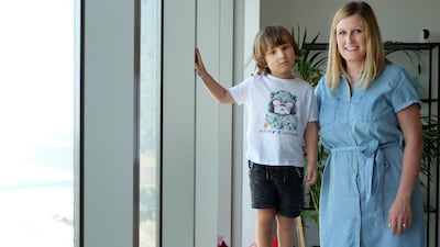 Katie Joukadjian with her son, James, 4. She took him to Dr Jörg Stöbel at the Chiropody Center in Dubai to treat the alignment of his feet using high-top shoes fitted with special insoles. Delores Johnson / The National