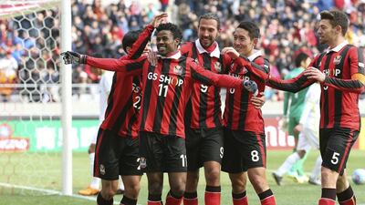 South Korea's FC Seoul Carlos Adriano de Souza Cruz, second from left, celebrates with his teammates after scoring a goal against Japan' Sanfrecce Hiroshima during a soccer match of the AFC Champions League at the World Cup Stadium in Seoul, South Korea, Tuesday, Mar. 1, 2016. (Lee Sang-hack/Yonhap via AP)