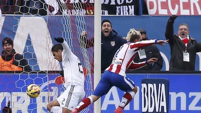 Atletico Madrid's Antoine Griezmann begins to celebrate as he scores his side's third goal in their 4-0 La Liga win over Real Madrid on Saturday. Sergio Perez / Reuters