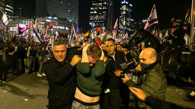 Israeli police officials detain a protester during clashes after a demonstration against the government's judicial overhaul in Tel Aviv. Getty