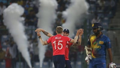 England's David Willey (L) celebrates with his teammate Jason Roy after taking the wicket of Sri Lanka's Milinda Siriwardana. REUTERS/Adnan Abidi