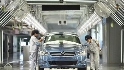 Employees working on a production line at Dongfeng Peugeot-Citroën Automobile plant in Wuhan, central China's Hubei province. The French car maker Peugeot posted a record first-half profit on Wednesday. Courtesy: China Out