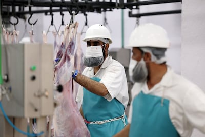 Workers prepare sacrificial meat at an abattoir in Dubai's Al Qusais. Chris Whiteoak / The National