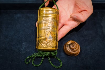 A gold lacquer inro and coiled snake netsuke (box) that were part of the Last Treasures From The Wrangham Collection sale by Bonhams in 2021. EPA