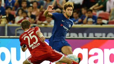 Chelsea's Marco Alonso is challenged by Bayern Munich's Thomas Muller. Roslan Rahman / AFP
